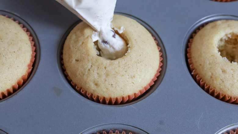 filling cupcakes with cannoli cream