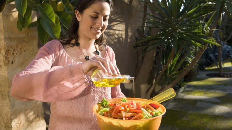 pouring oil on vegetables