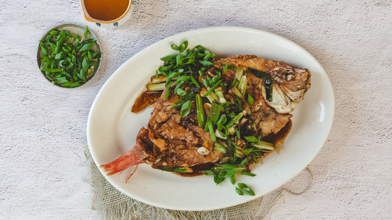 Whole fish with sauce and scallions