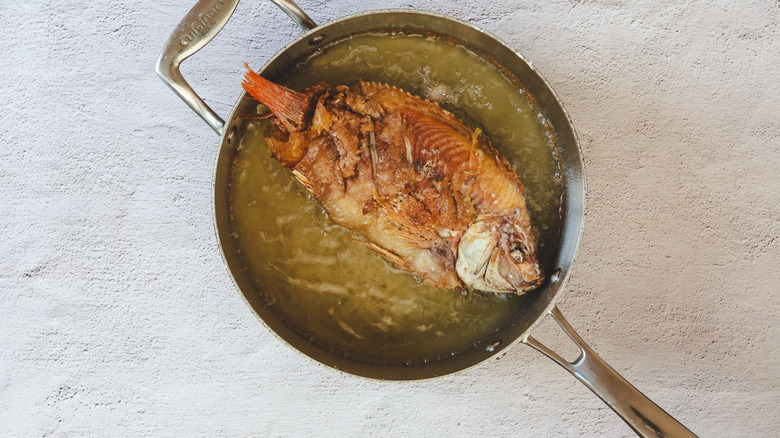 Frying fish in pan