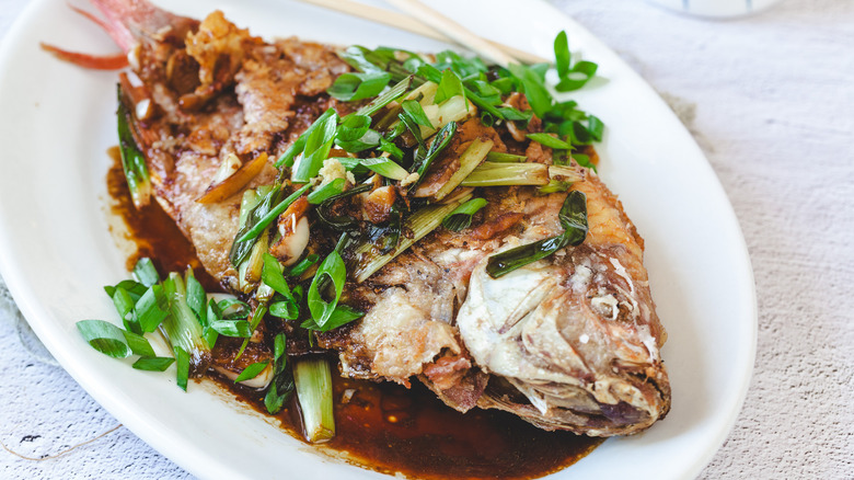 Whole fish with sauce and scallions