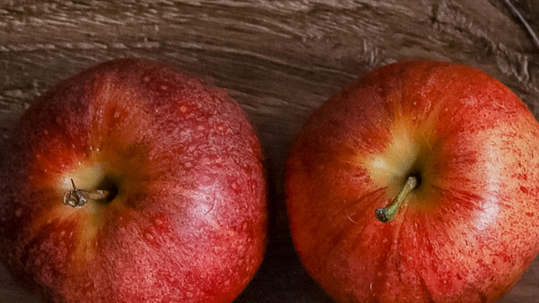 unpeeled apples sitting on table