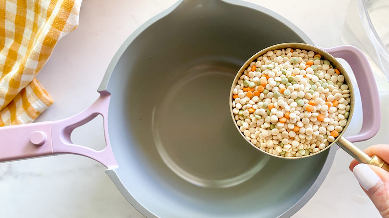 adding couscous to a pot