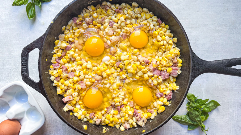 raw eggs on cooked corn