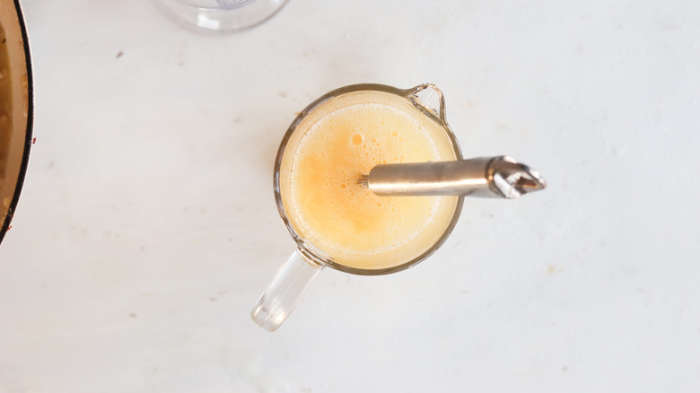 egg whites and chicken broth in a measuring cup