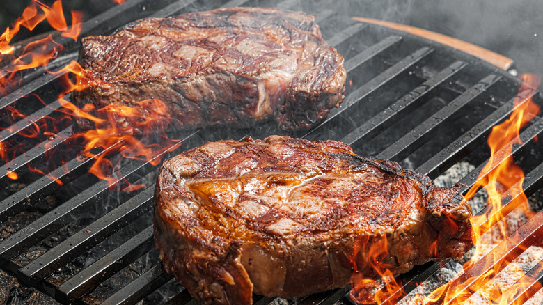 Steak on grill flame