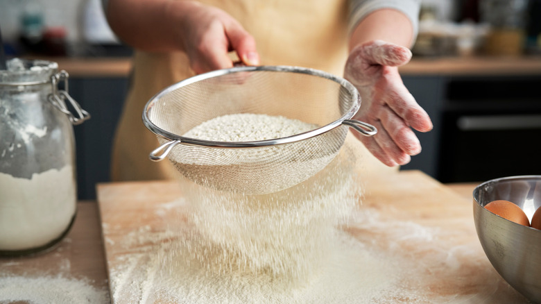 Person sifting flour