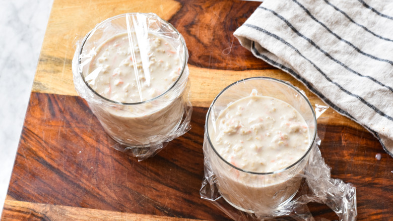 carrot cake overnight oats in glasses with plastic wrap