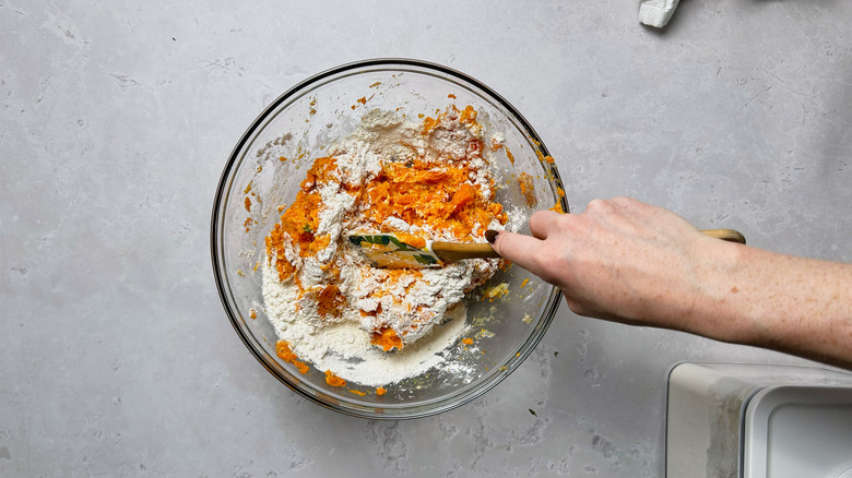 mixing carrot into flour