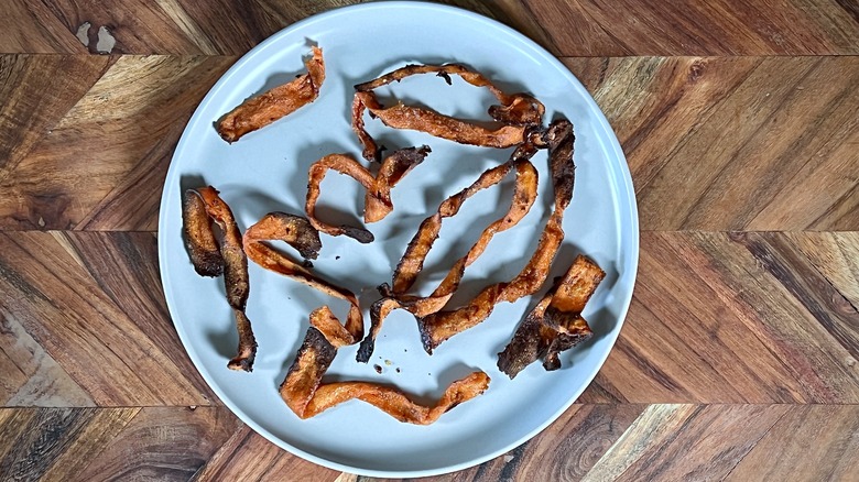 Carrot bacon strips on plate