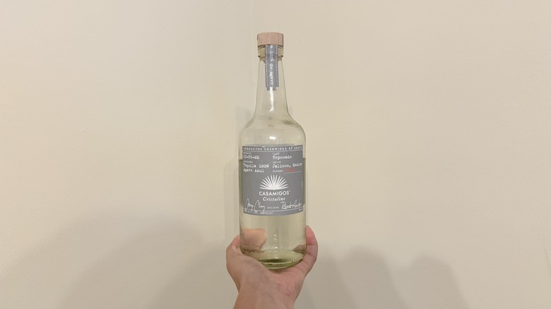 Bottle of Cristalino against wall