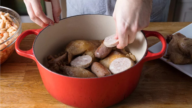 Sausages and duck confit in pot