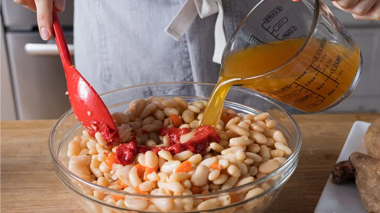 Stock poured on drained beans