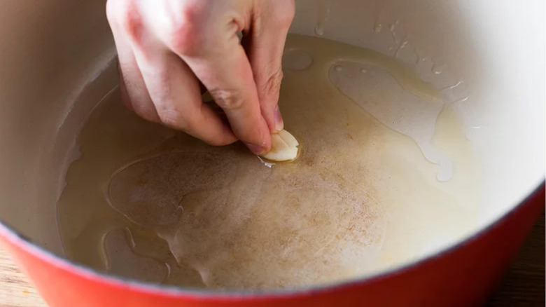 Pot being greased with garlic