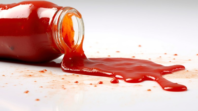 Bottle spilling red ketchup