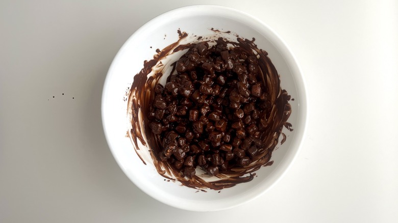 Marshmallows in melted chocolate in bowl