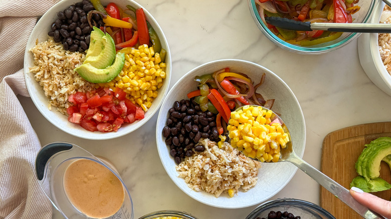 adding corn to bowl