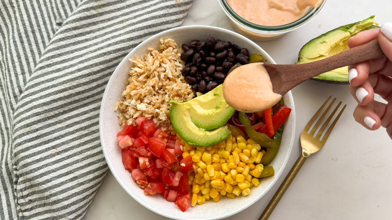 adding sauce to bowl