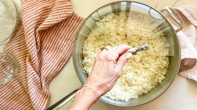 putting lid on pan