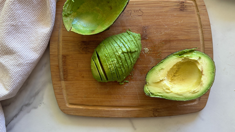 sliced avocado on board