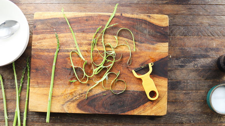 Peeler shaving asparagus ribbons