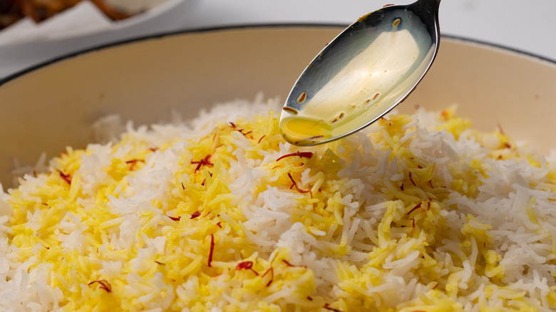 Pouring saffron milk on rice