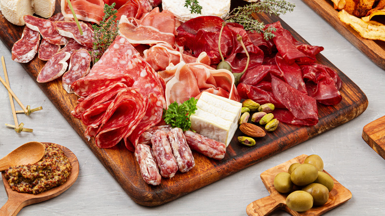Charcuterie platter with meats, cheeses, and olives