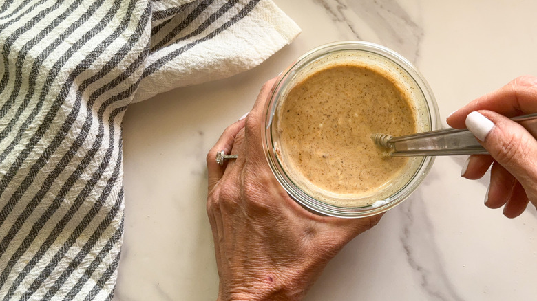 hand stirring dressing in bowl