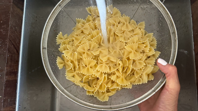 rinsing pasta in colander