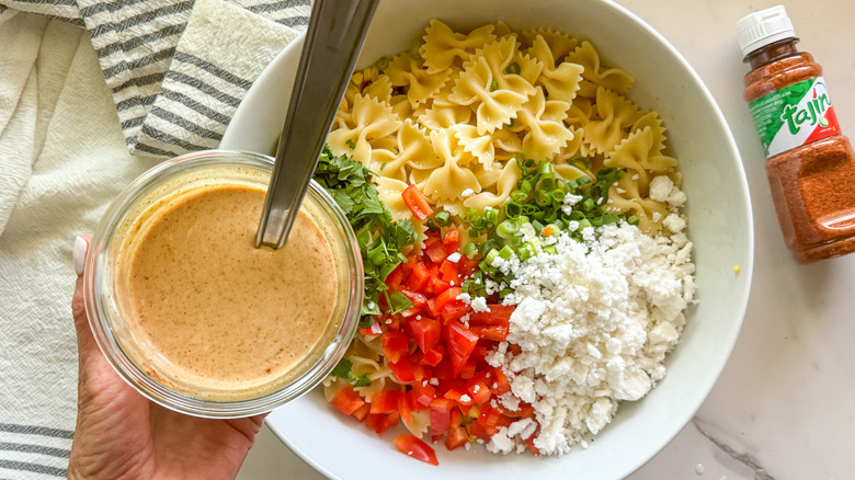 adding dressing to salad