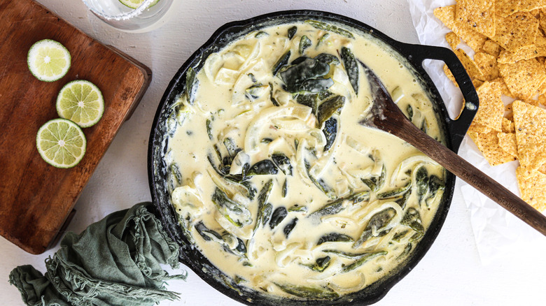 strips of poblano peppers and onions in cream sauce in a skillet