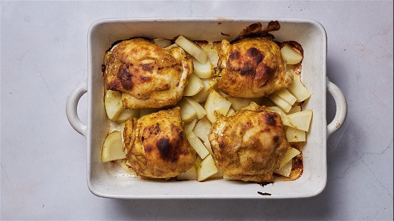 roasted chicken and potatoes in pan