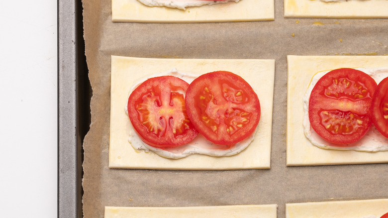 preparing cheese and tomato danishes