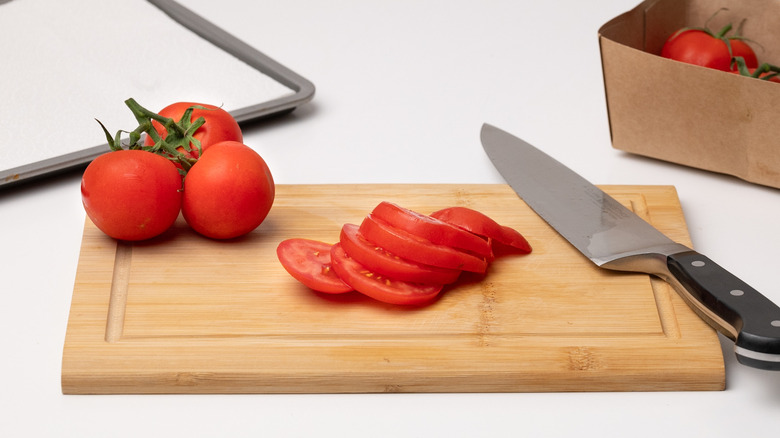 slicing tomatoes on chopping board