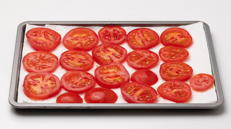 sliced tomatoes on kitchen towel