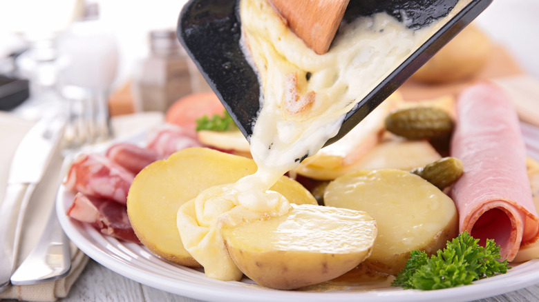 Raclette melted cheese over potatoes