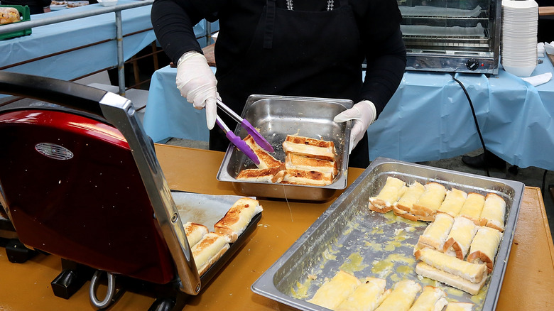 woman making cheese rolls