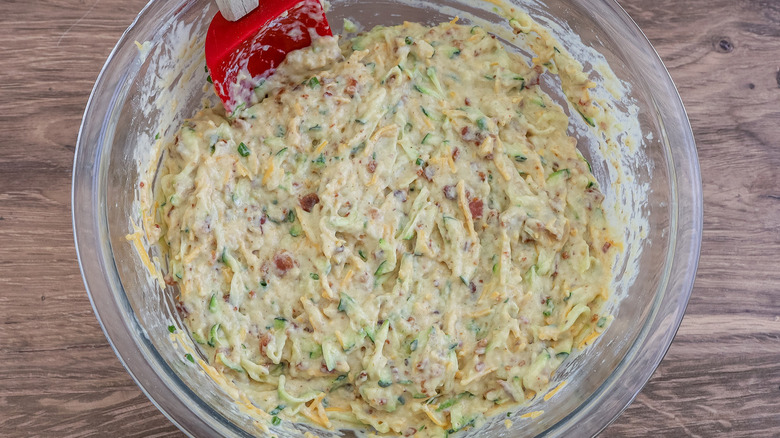 cheesy zucchini muffin batter in bowl