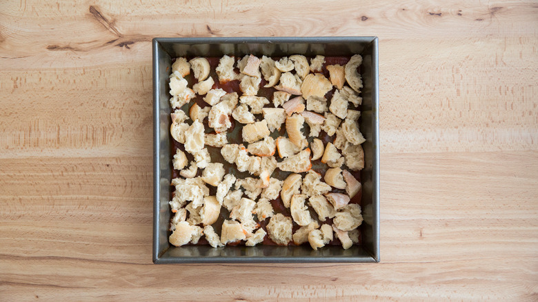 torn bread lining baking pan