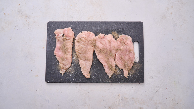 seasoned chicken on cutting board