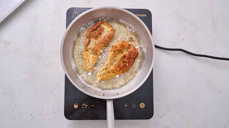 frying chicken in skillet