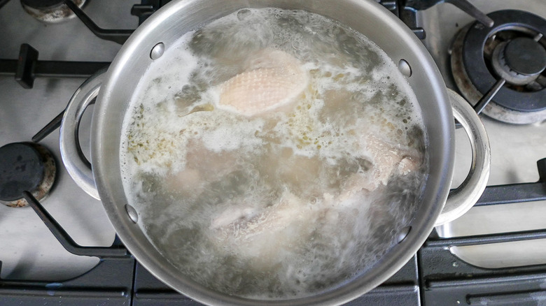 chicken thighs cooking in water