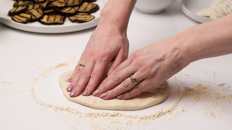 shaping pizza bases with dough