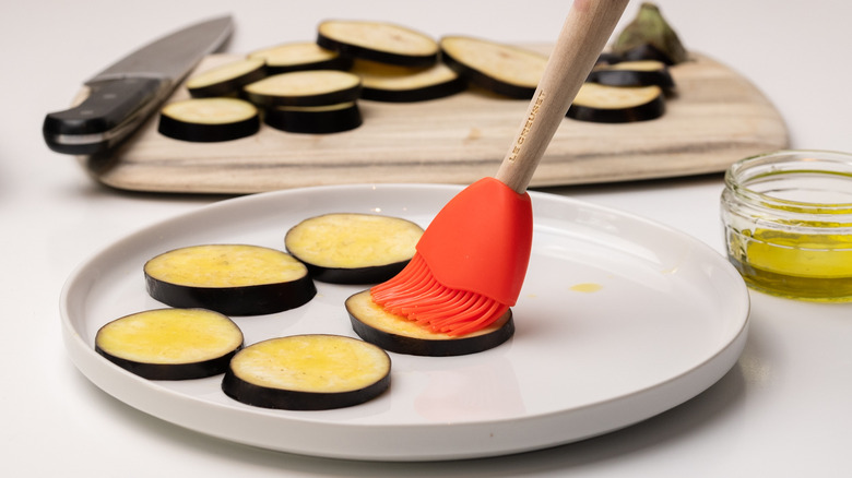 brushing eggplant slices with oil