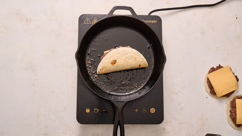 tortilla with burger in skillet