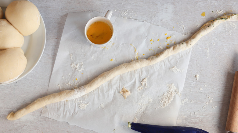 filled pretzel dough rolled into log