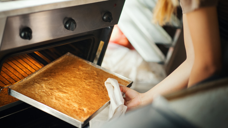 cake being removed from oven