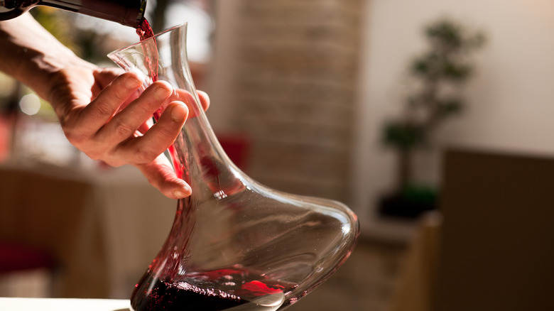 pouring wine into a decanter