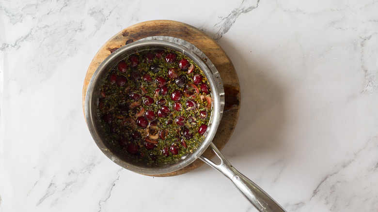 Cherries and herbs in pan