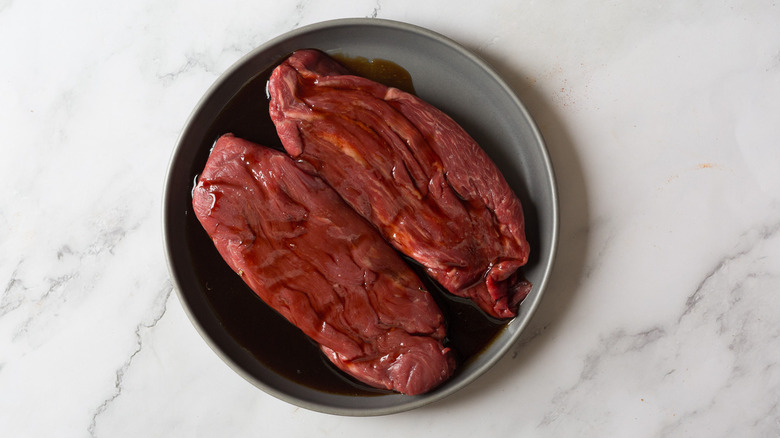 Steak in cherry juice on plate